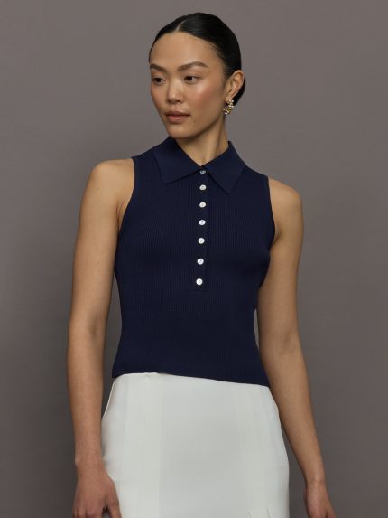 Model wears a navy collared button up tennis tank.