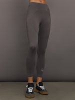 Model wearing gray leggings with a small logo.