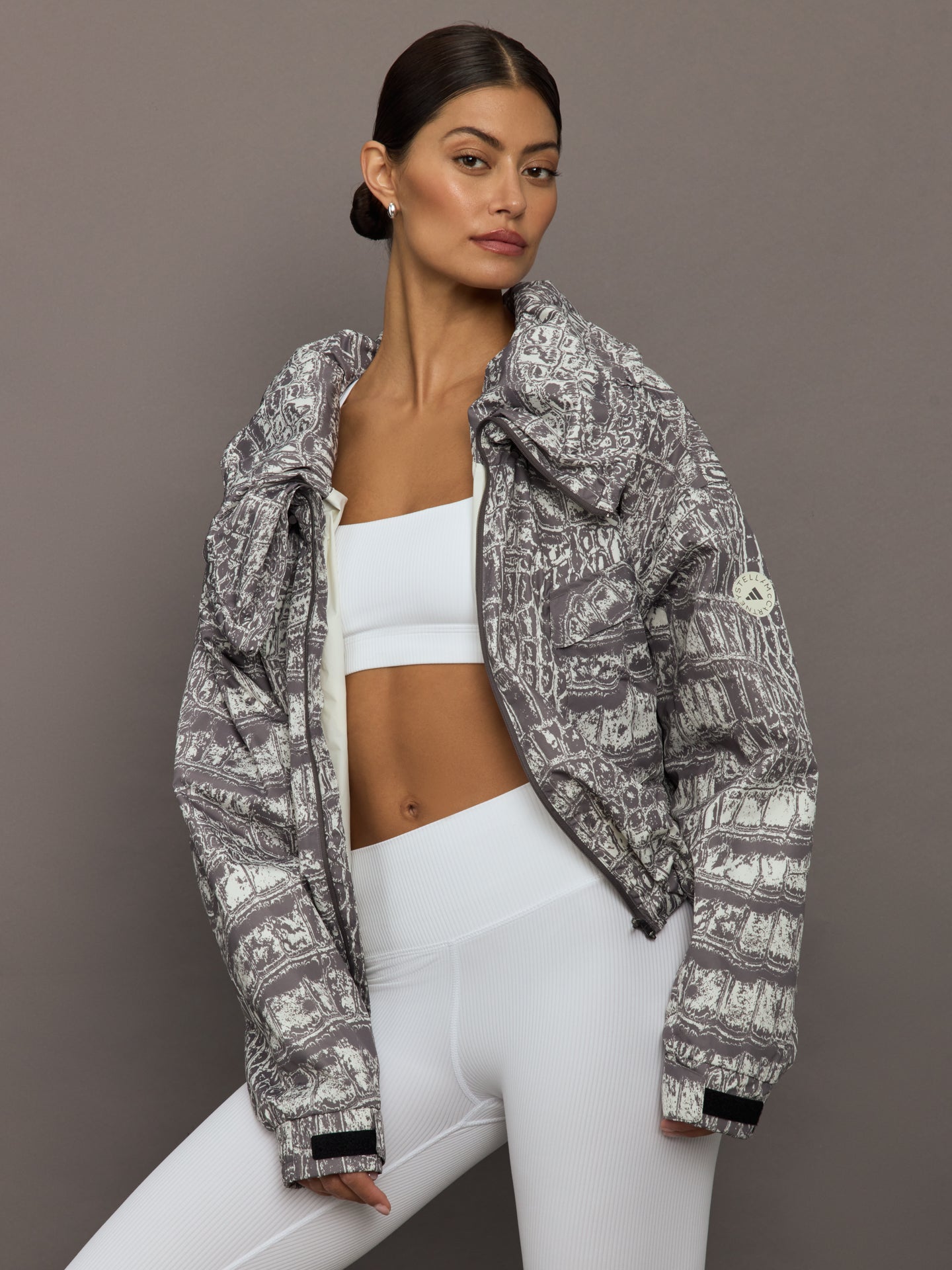 ADID-JX9360-IVRYGRYLT-aSMC-Item-Jacket-Printed-color-Almond-Milk-Smc-Charcoal_37097-Edit Model wears an almond/charcoal patterned jacket.