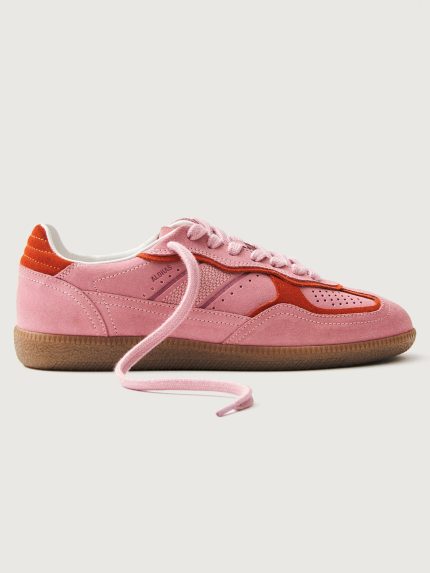Pink clay colored suede low top lifestyle sneaker with red detailing.