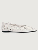 White flat shoe with cut-out design.