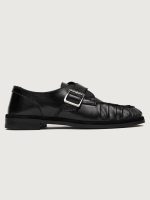 Black leather dress shoe with a buckle.