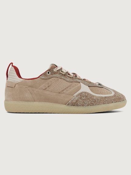 Gray/taupe low top lifestyle sneaker with red heel detail.