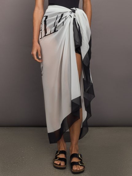 Model wears balmain print skirt with a long, flowy silhouette and a tie closure at the waist.