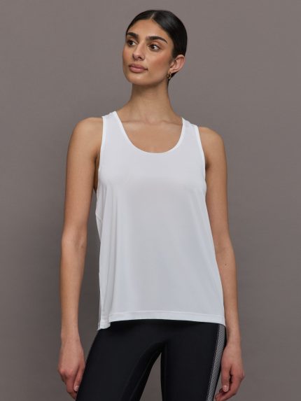 Model wears a scoopneck white tank top. 