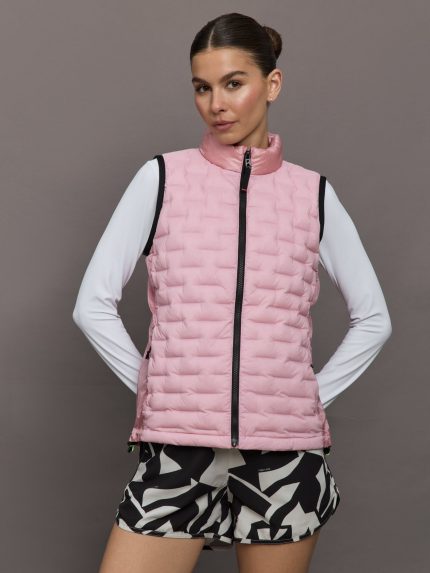 Model wears a tube quilted pastel pink vest with black seams.