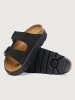 Black sandal with a brown insole on a light gray background