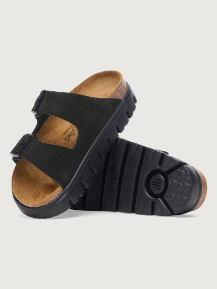 Black sandal with a brown insole on a light gray background