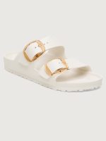White sandal with gold buckles.