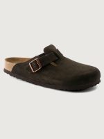 Brown clog shoe with a bronze buckle on a light gray background