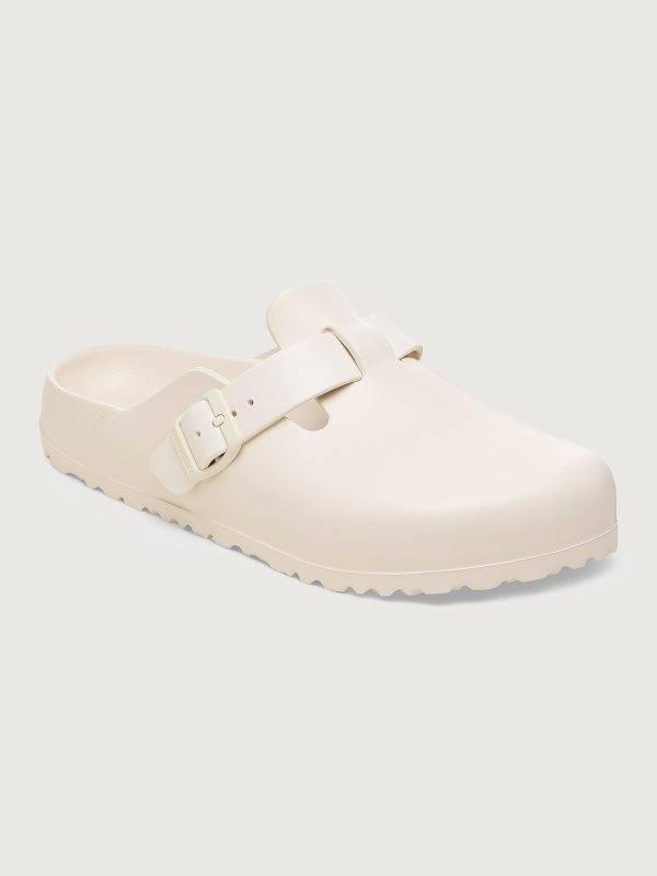 A pair of eggshell white Birkenstock Boston EVA sandals with buckle closure.