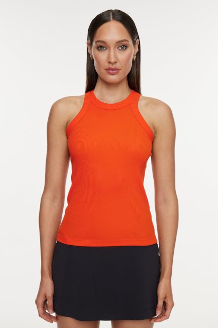 Model wears a high neck bright orange tank top.