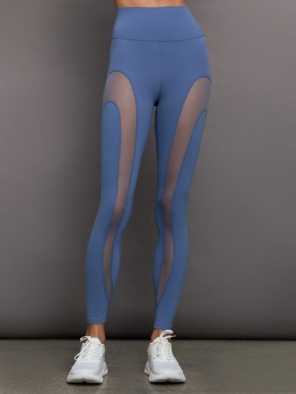 Model wears a periwinkle blue buttery soft pair of leggings with mesh detailing down the front of the legs.
