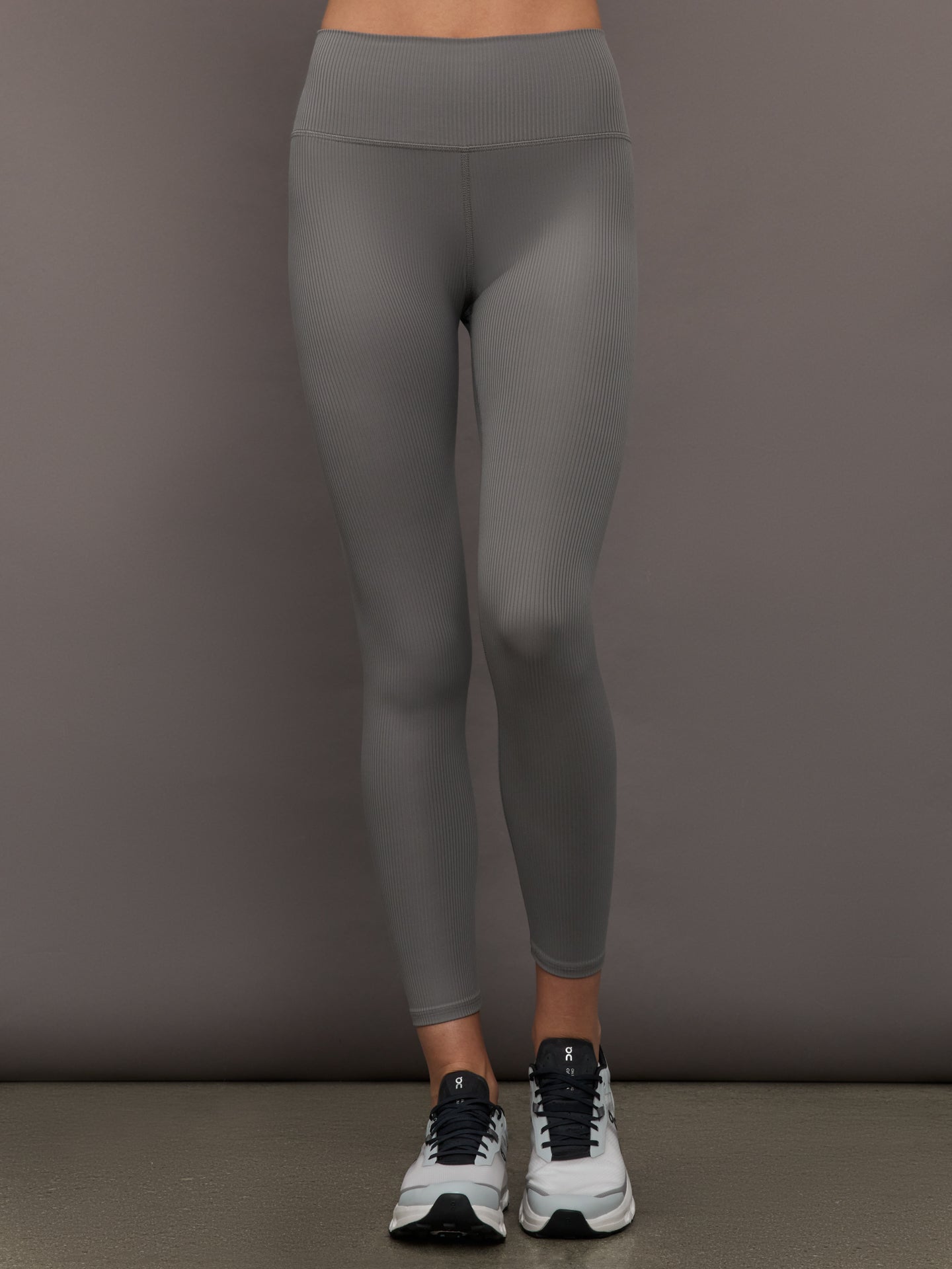 CARB-YD1016R-GREY-25FAL-High-Rise-Legging-in-Ribbed-Melt-color-Steel-Grey_41069-Edit Model wears high-rise leggings in steel grey with a ribbed texture, with a wide waistband and a form-fitting silhouette.