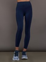 Model wearing navy blue high waisted leggings with pockets.