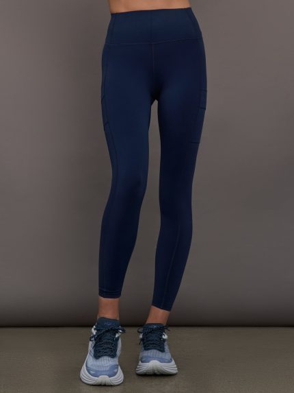 Model wearing navy blue high waisted leggings with pockets.