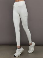 Model wears a highly compressive white high waisted legging with side pocket on outer thigh.