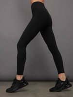 Model wears black high-rise, full-length leggings with a matte finish and a smooth, body-hugging fit.