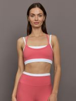 Model wears a white with rosewood overlay sports bra perfect for medium impact activities.