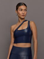 Model wearing a navy blue one-shoulder bra top with a sleek shine finish.