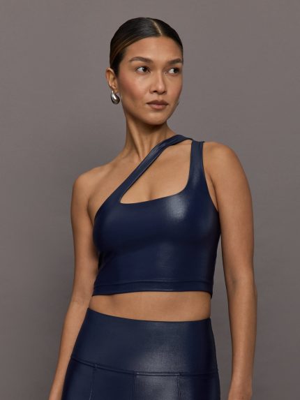 Model wearing a navy blue one-shoulder bra top with a sleek shine finish.