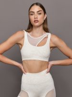 Model wears Snow leopard sports bra with a white mesh overlay, featuring a scoop neckline, wide straps.