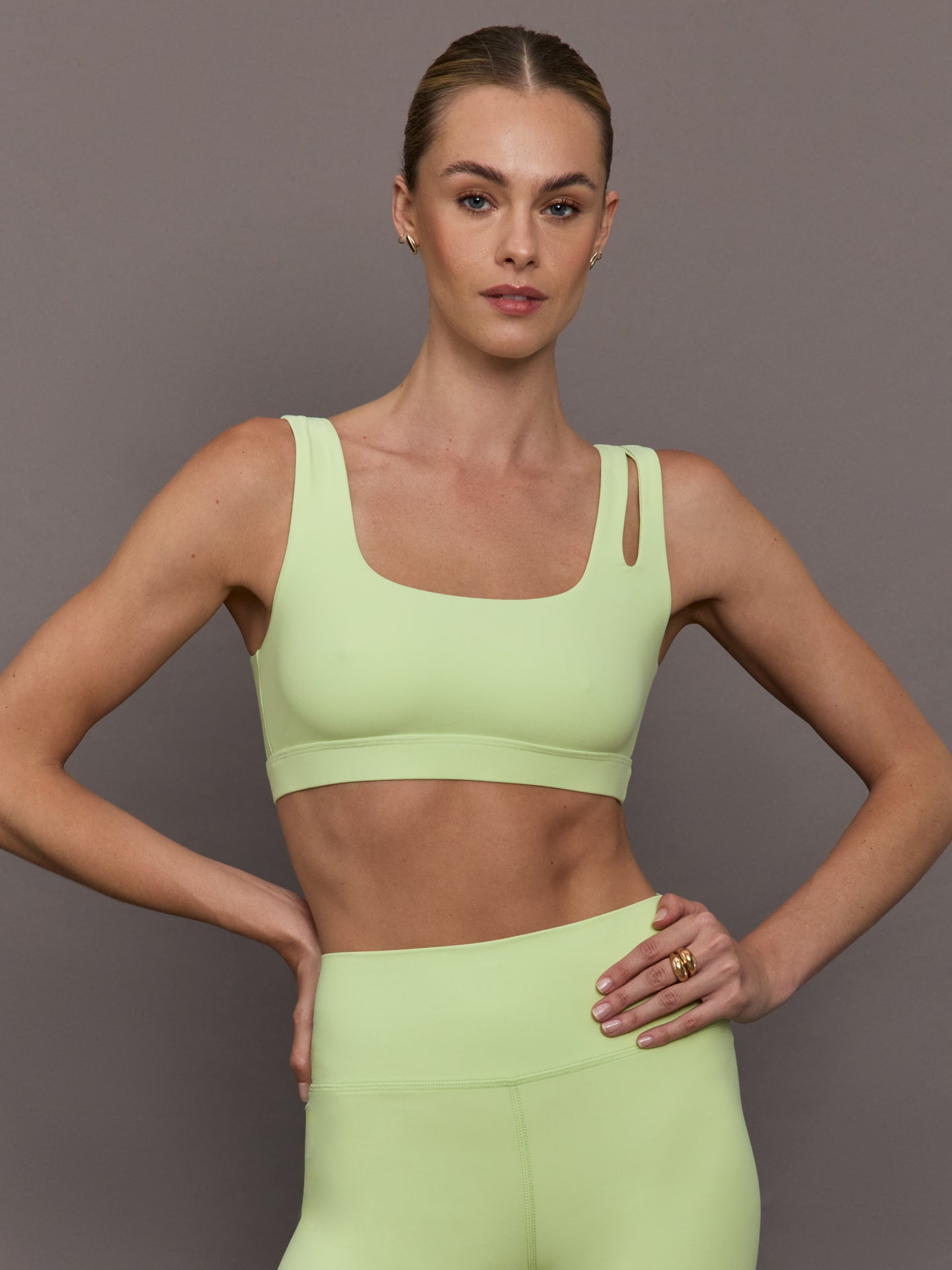 CARB-YD2027-MATCHA-25FAL-Cutout-Bra-in-Melt-color-Matcha_40938-Edit Model wearing a light green cutout sports bra.