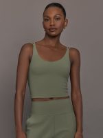 Model wears an army green tank top with double straps.