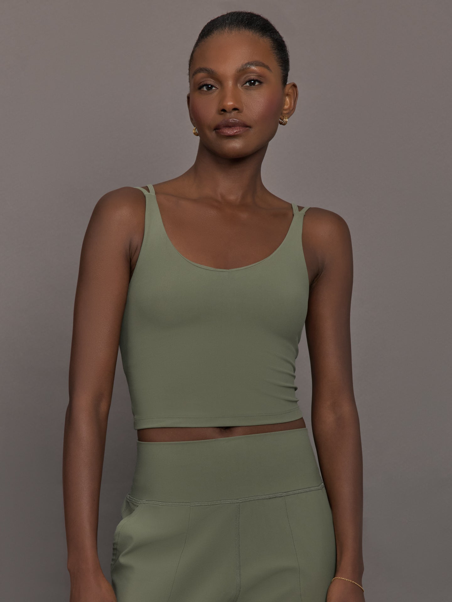 CARB-YD363-GRN-25SM-V-Neck-Longline-Tank-in-Melt-color-Moss_28278-Edit Model wears an army green tank top with double straps.