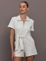 Model wearing a light gray romper with zipper closure.