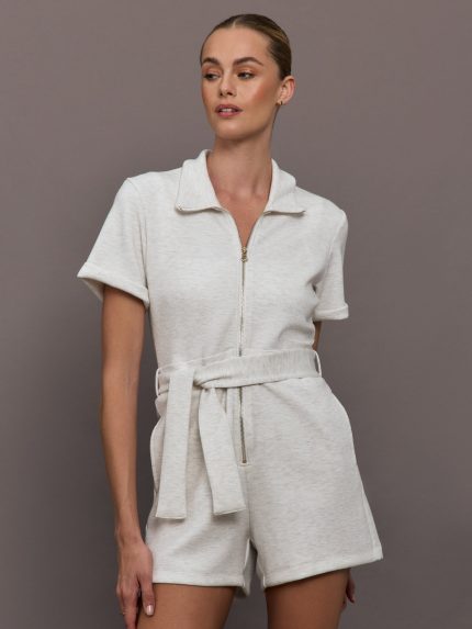 Model wearing a light gray romper with zipper closure.