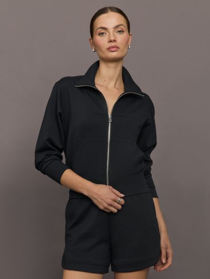 Model wears black Interlock Full Zip Jacket featuring a sleek, minimalist design with a high collar and full-length zipper.