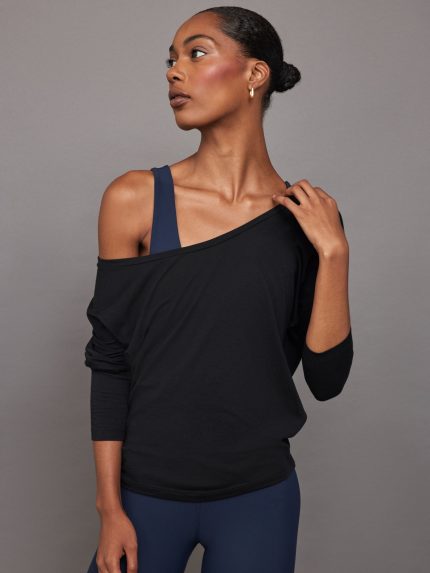 Model wears off-shoulder long-sleeve tee with a relaxed fit.