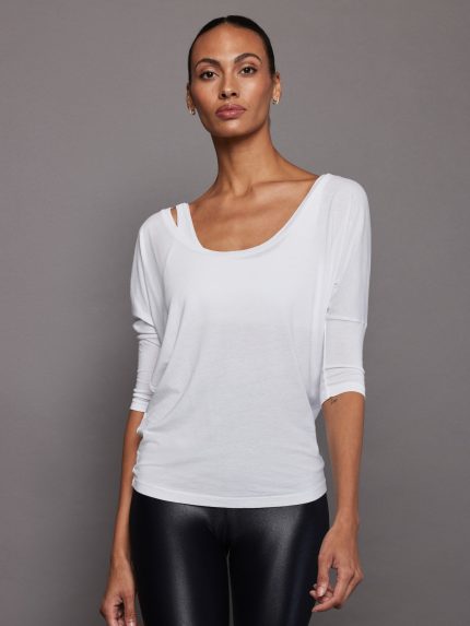 Model wears white off-the-shoulder tee with a relaxed fit and deep neckline. 