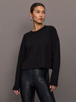 Model wears a black crewneck oversized french terry sweatshirt.