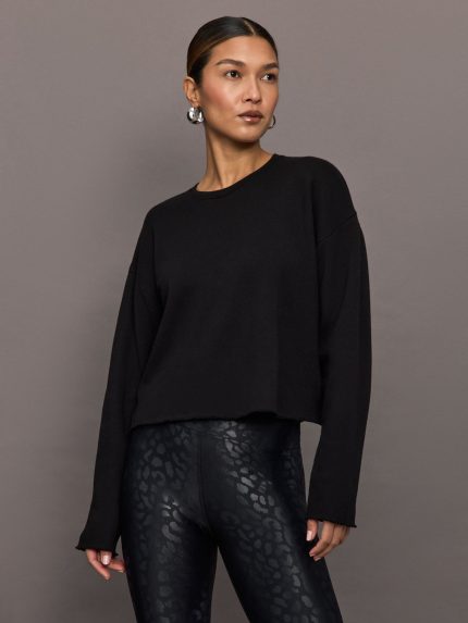 Model wears a black crewneck oversized french terry sweatshirt.
