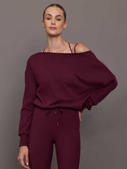 Model wearing off should sweatshirt in color fig