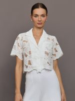 Model wears cropped Resort Shirt with button up front, a relaxed fit, and leaf embroidery detailing.