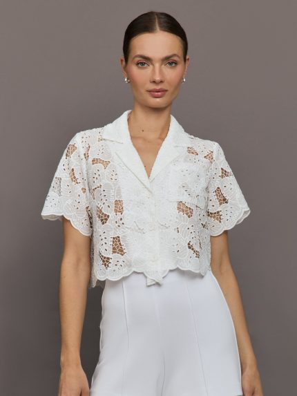 Model wears cropped Resort Shirt with button up front, a relaxed fit, and leaf embroidery detailing.    