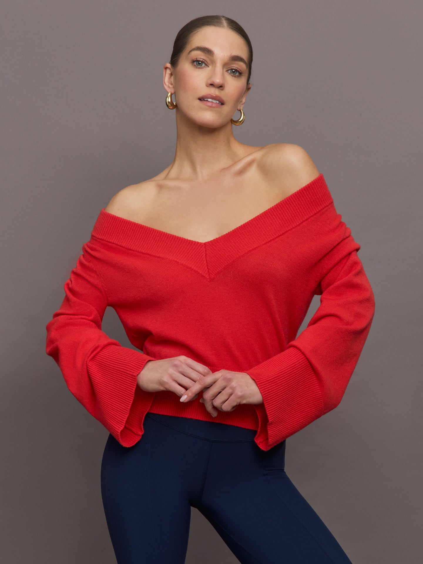 CARB-YD6154-RED-25SS-Bell-Sleeve-Off-Shoulder-Sweater-color-Bittersweet_9508-Edit Model wears red off-shoulder sweater with bell sleeve.