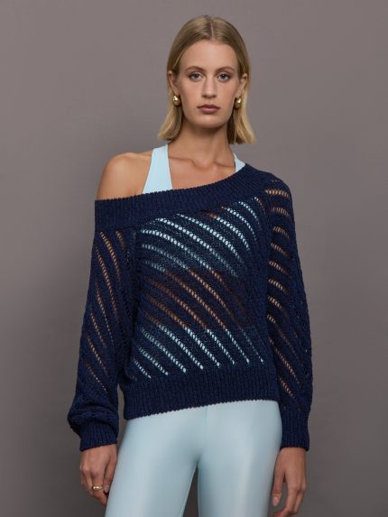 Model wears a navy off shoulder mesh cardigan with diagonal pattern.