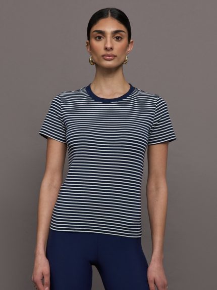 Model wears a navy and white horizontal striped short sleeve ringer tee.