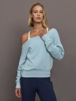 Model wears a light blue off shoulder french terry sweatshirt.