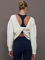 Model wearing Ivory pullover sweater with a twist in the back.
