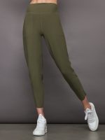 Model wears olive, high-rise joggers with a slim, relaxed fit, slightly cropped legs, and tulip-shaped hems.