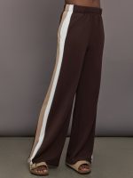 Model wearing Brown wide-leg pants with a white and beige stripe