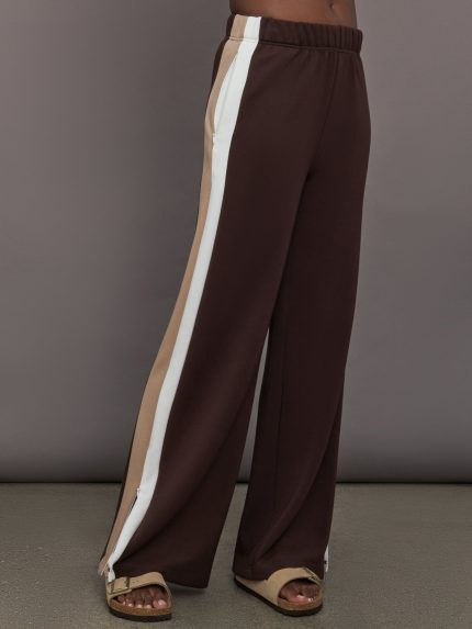 Model wearing Brown wide-leg pants with a white and beige stripe