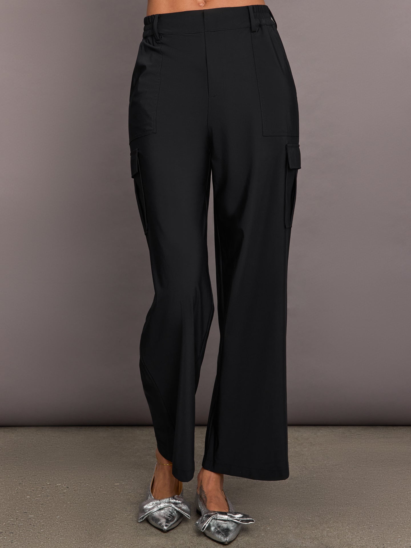 CARB-YD870-BLK-24HOL-Stretch-Woven-Wide-Leg-Cargo-Pant-color-Black_1291-Edit A pair of black stretch woven wide-leg cargo pants with oversized pockets, displayed on a model without showing the upper part of the body.