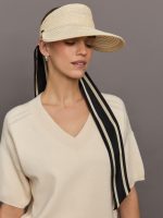 Model wears a straw visor with black and ivory ties.