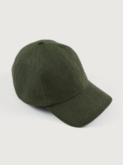 Model wears olive linen baseball cap with an embroidered logo on the front and a ruched elastic back.